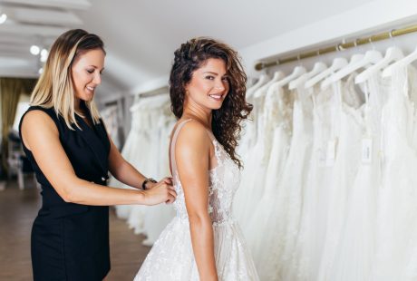 Future mariée brune choisissant sa robe de mariée dans une boutique de mariage